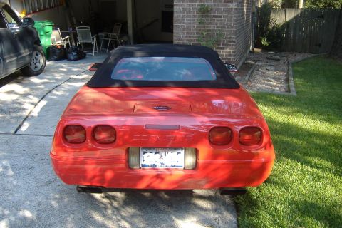 1994 Chevrolet Corvette - Rear view of a red 1994 Chevrolet Corvette convertible parked in a driveway.