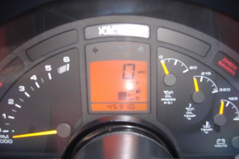 1994 Chevrolet Corvette - Close-up of a car's dashboard gauges, including a digital odometer displaying 45310 miles.