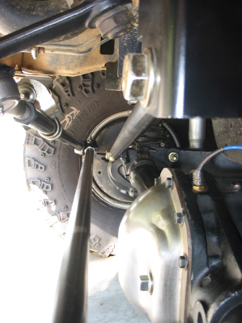 1995 Ford Bronco - Undercarriage view of a vehicle's suspension and steering system, focusing on the front axle and differential.
