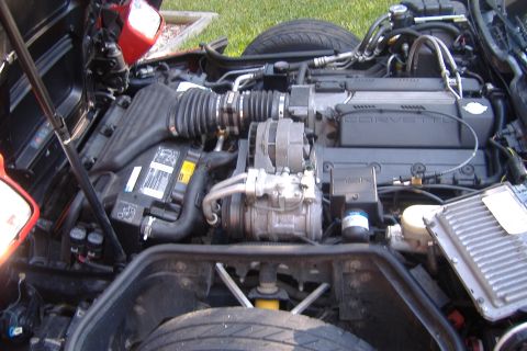1994 Chevrolet Corvette - The engine bay of a 1994 Chevrolet Corvette, showing the V8 engine and associated components.
