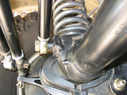 1995 Ford Bronco - Detailed view of the suspension system, focusing on the coil spring and linkage components.