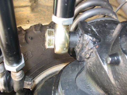 1995 Ford Bronco - Detailed view of a vehicle's suspension system, focusing on the tire and shock absorber assembly.