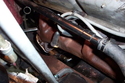 1995 Ford Bronco - Wrench on flange nut, thru the inner fender and over frame rail.