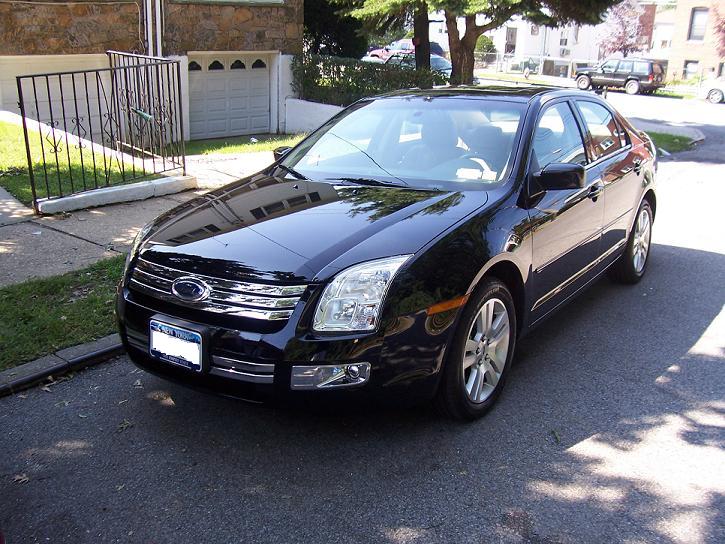 Black sedan front 3/4 view. Likely a 2006 Ford Fusion