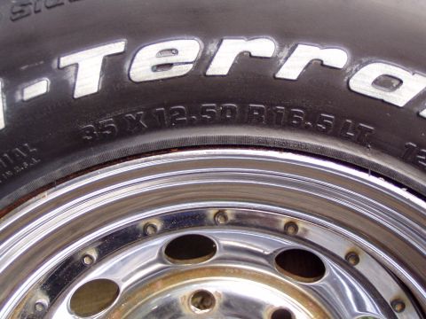 1989 Ford F-250 - A close-up view of a BFGoodrich All-Terrain T/A tire mounted on a chrome wheel.