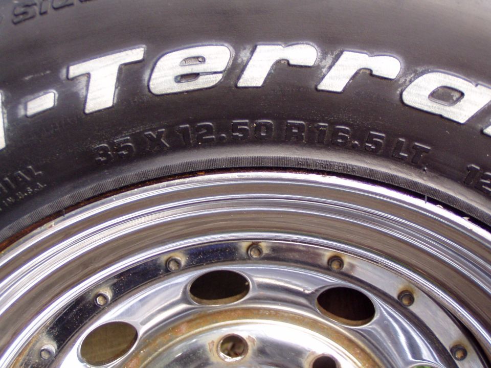 Close-up of 35x12.50R16.5LT tire sidewall on polished chrome wheel