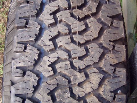 1989 Ford F-250 - A close-up view of a tire tread shows wear and a distinct block pattern, with website text visible at the bottom.
