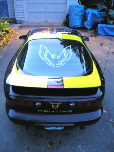 1984 Pontiac Fiero - This 1994 Pontiac Trans Am features a distinctive yellow stripe and a prominent bird decal on its rear window.