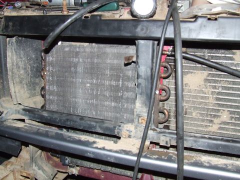 1995 Ford Bronco - The front of a vehicle is shown with the radiator and transmission cooler exposed, revealing the internal components.