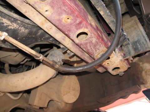 1995 Ford Bronco - Close-up of vehicle undercarriage, focusing on frame and mechanical components.