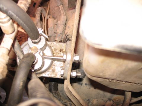 1995 Ford Bronco - Close-up view of a transmission fluid filter, showing the IN and OUT ports.