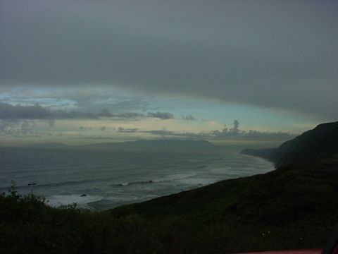 1979 Ford Bronco - A cloudy day over the ocean with waves breaking on the shore.