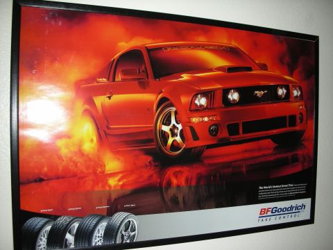 1998 Ford Crown Victoria - framed BFGoodrich tire advertisement poster shows a red modified Mustang coupe against a fiery background, with tires lined up below.
