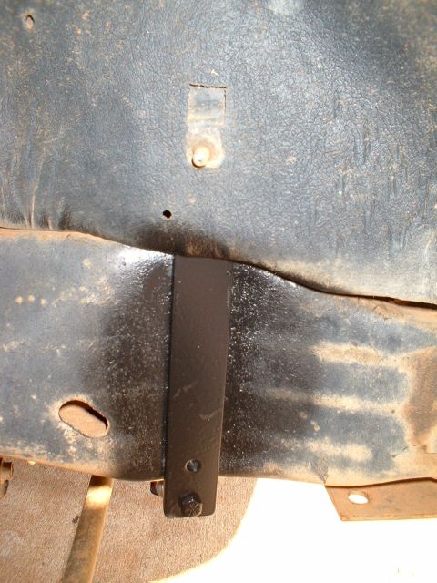 1995 Ford F-150 - Bracket attached to the underside of a vehicle's frame.