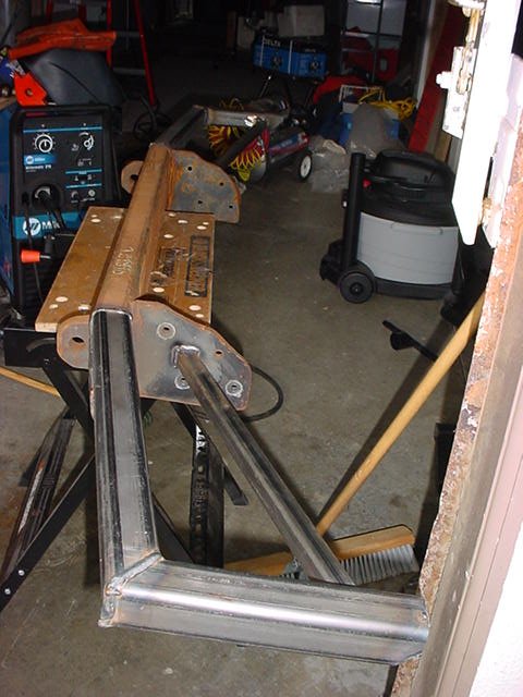 1979 Ford Bronco - Garage scene with welding equipment, metal parts, and a shop vacuum visible.