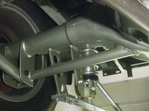 1990 Ford Mustang - Close-up view of a rear suspension system an adjustable coilover shock absorber and associated linkage.