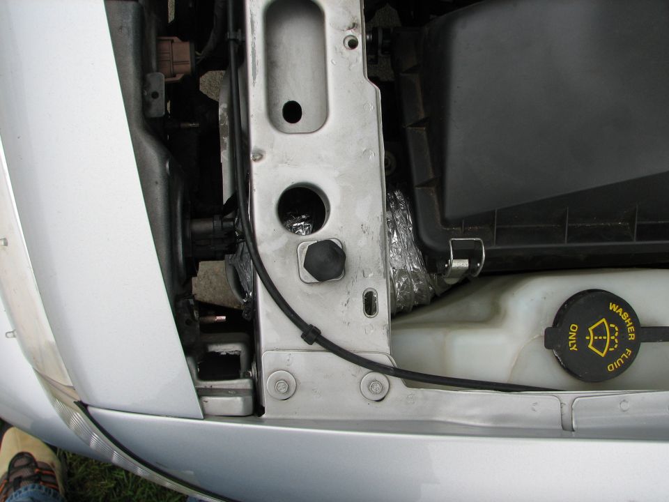 2002 Ford Crown Victoria engine bay showing airbox, washer fluid reservoir, and metal bracing