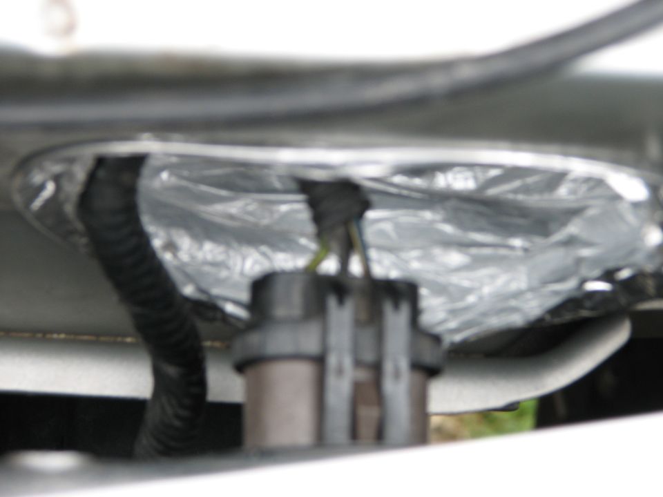 Engine bay wiring harness with foil insulation and a connector