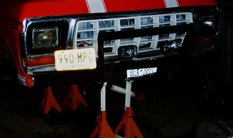 1978 Ford Bronco - Front view of a red truck, possibly a 1979 Ford F-Series, on jack stands.