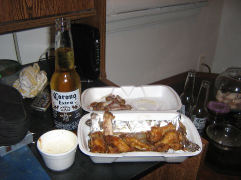 1995 Ford Bronco - A meal of chicken wings and other food, accompanied by a bottle of Corona Extra, sits on a counter.