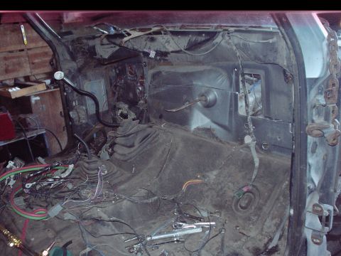 1984 Ford Bronco - Gutted truck interior stripped to the bare floor pan and firewall, with dash, seats and carpet removed and the transmission tunnel, shifter…