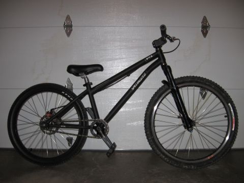 1997 Ford Probe - A black Specialized bicycle is shown in a side profile against a garage door.