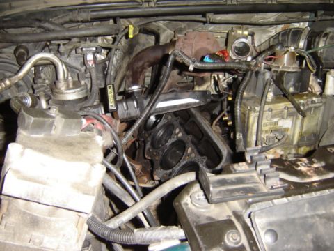 1992 Ford Bronco - Engine bay with cylinder head removed, revealing internal engine components and surrounding parts.