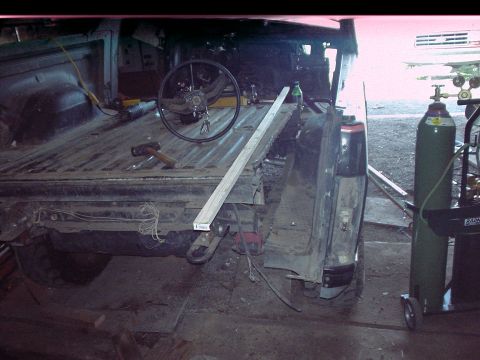 1984 Ford Bronco - This modified Ford Bronco appears to be undergoing a significant structural alteration, with its bed section removed.