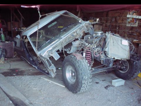 1984 Ford Bronco - This 1984 Ford Bronco appears to be undergoing a significant modification or repair, with its front end disassembled and the body suspended.