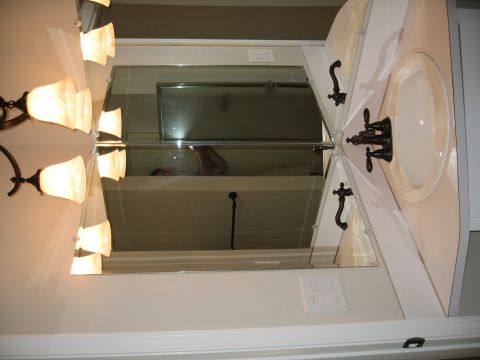 1994 Ford Probe - A bathroom vanity with a sink and mirror is shown, with a reflection of a person in the shower visible.