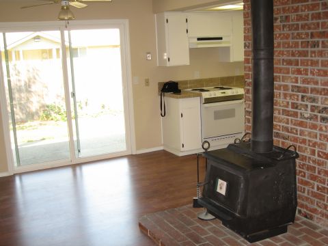 1994 Ford Probe - A domestic scene showing a wood-burning stove and kitchen area, with a view to the outdoors through sliding glass doors.