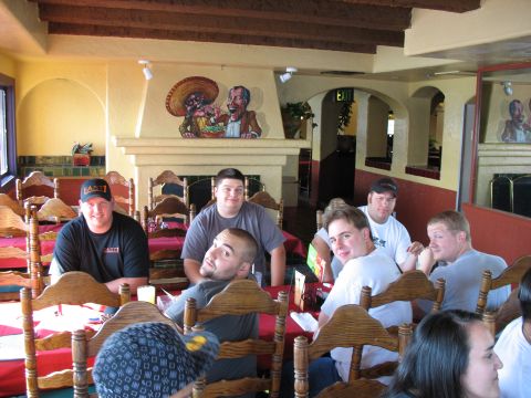 1997 Ford Probe - Several men are seated at tables in a restaurant, with a mural above the fireplace.