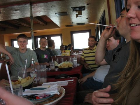 1997 Ford Probe - A group of friends enjoys a meal together at a restaurant, with drinks and chips on the table.