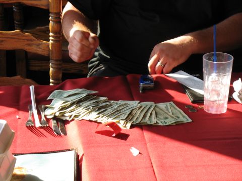 1997 Ford Probe - A table is set with money, cutlery, and a toy car, suggesting a game or transaction.