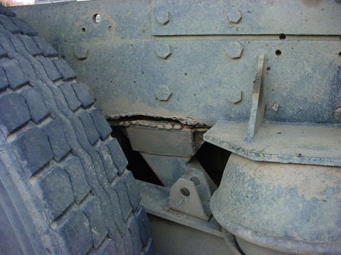 1979 Ford Bronco - Detail of a truck's frame and tire, showing robust construction and suspension elements.