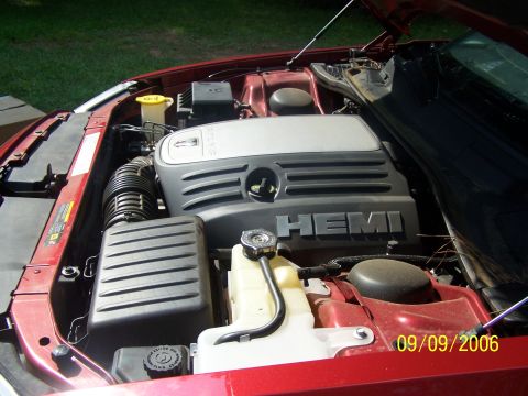 1979 Ford F-150 - The engine bay of a red vehicle is visible, showing the HEMI engine cover and a date stamp.