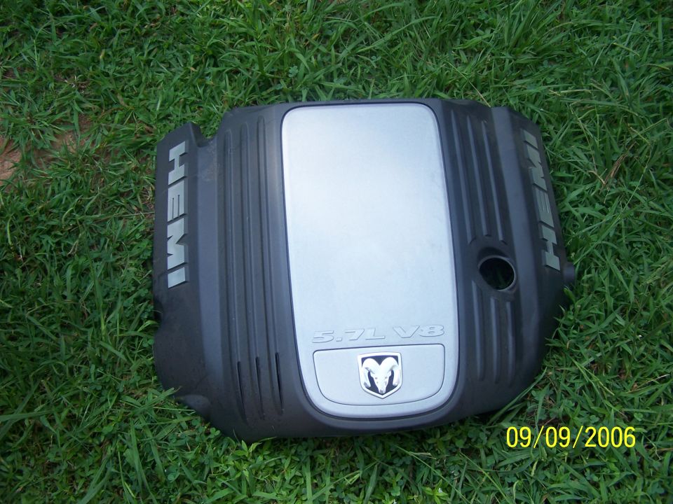 Black engine cover with silver insert, "HEMI" and "5.7L V8" text, and Dodge Ram logo