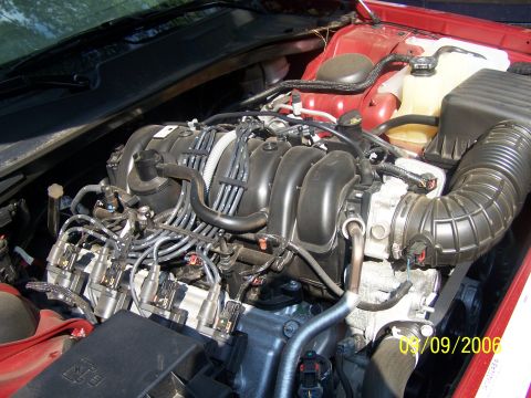 1979 Ford F-150 - Engine bay details, including the air intake system and coolant reservoir. Date stamp is 03/09/2006.