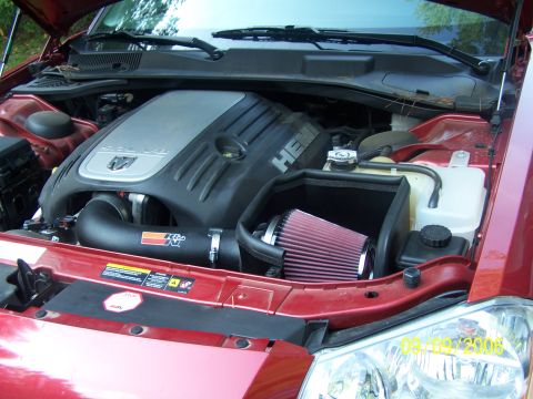 1979 Ford F-150 - The engine bay of a red vehicle displays a K&N air intake system and a HEMI engine cover.