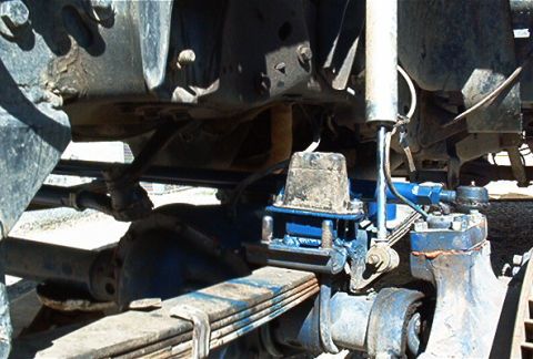 1986 Ford Bronco - Undercarriage view of a truck's rear axle and suspension components.
