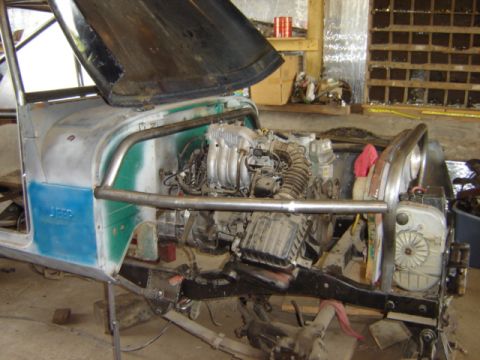 1992 Ford Bronco - Jeep CJ-6 undergoing engine work, showing the engine bay and chassis construction.