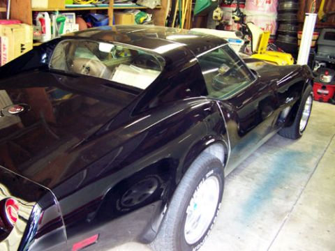 1975 Chevrolet Corvette - Black 1975 Chevrolet Corvette parked indoors, showing its distinctive body lines and wheels.