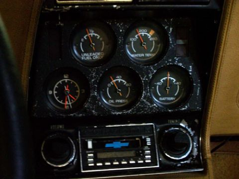 1975 Chevrolet Corvette - Interior view of a car's dashboard, showing various gauges and a radio unit.