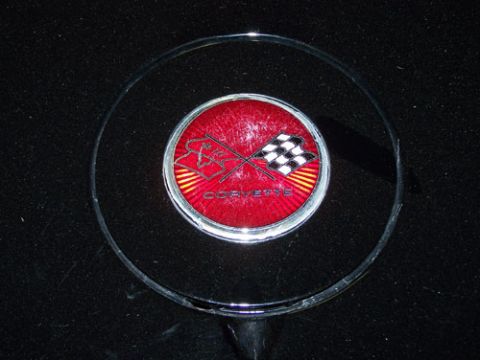 1975 Chevrolet Corvette - The emblem clearly reads "CORVETTE" and features the iconic checkered flags.