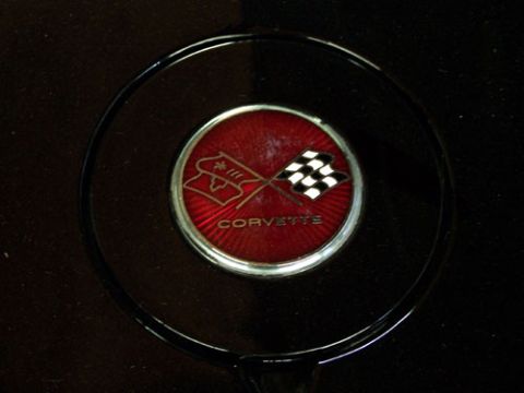 1975 Chevrolet Corvette - Close-up of a Corvette emblem, confirming the vehicle's identity and model year.
