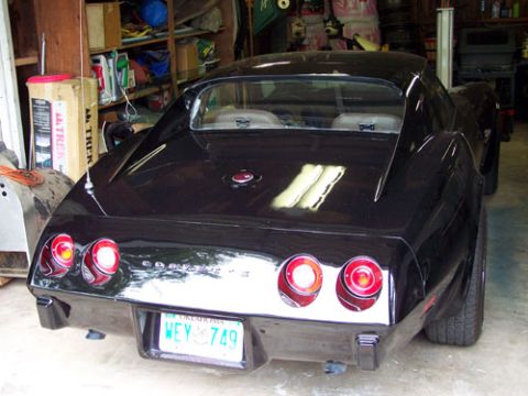 1975 Chevrolet Corvette - Rear view of a black 1975 Chevrolet Corvette parked in a garage. The Oklahoma license plate reads WEY 749.