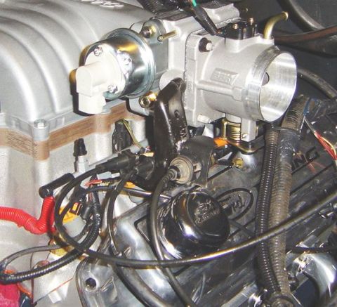 1986 Ford Bronco - Close-up of engine components, including a throttle body and valve cover with a Ford logo.