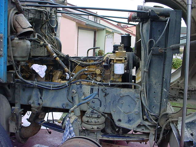 Close-up of a large diesel engine and its associated plumbing and wiring