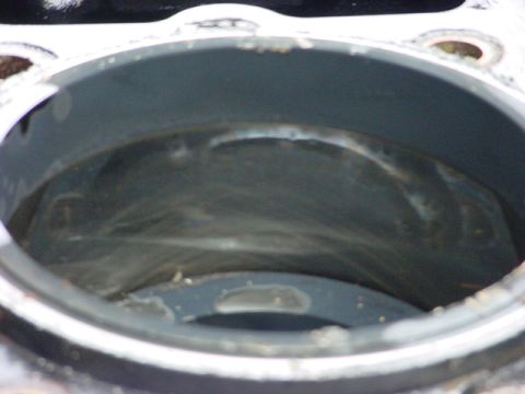 1979 Ford Bronco - Close-up view of an engine cylinder showing internal wear and debris, with a watermark indicating the source.