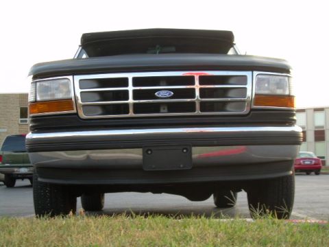 1992 Ford Bronco - Front view of a 1992 Ford Bronco with a chrome grille and black soft top.